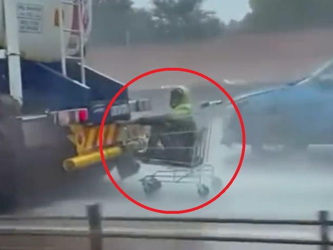 Wild moment man in trolley clings to truck