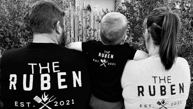 The Ruben Wood Smokers owners Carl Purdon and Lacey Marsh sporting their businesses merchandise with their son.