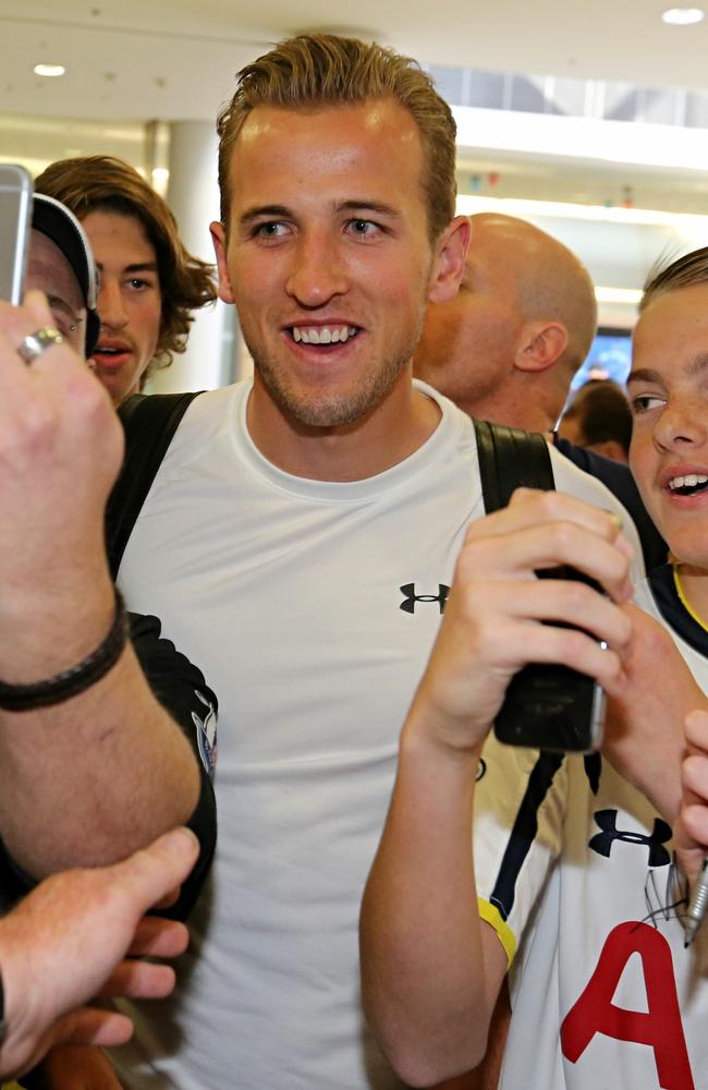 Spurs striker Harry Kane poses with fans at Sydney airport on Thursday.