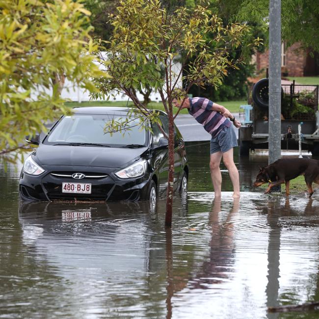 Residents inspect the damage.