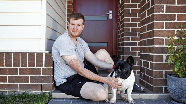 Rhys Callaghan, with his dog George, is worried about the future of his home. Picture: Sam Ruttyn