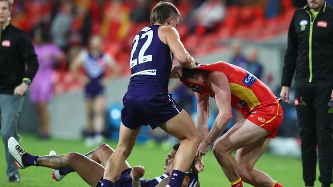 GOLD COAST, AUSTRALIA - JUNE 27: Pearce Hanley of the Suns and Caleb Serong of the Dockers grapple during the round 4 AFL match between the Gold Coast Suns and Fremantle Dockers at Metricon Stadium on June 27, 2020 in Gold Coast, Australia. (Photo by Chris Hyde/Getty Images)