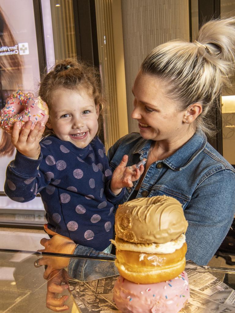 Three year old Summer Simon tries out the donuts at Brooklyn Donuts with her mother Roxy Simon. Friday, August 20, 2021. Picture: Nev Madsen.