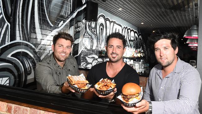 Southside Social Business Partners Skye Graham, Assad Mansour and John Jovan enjoy some of the burgers from their menu. Picture: Jason Sammon