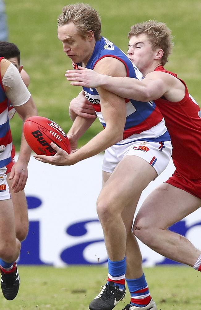 Bulldogs defender Luke Barmby gets a handball away under pressure. Picture: Sarah Reed