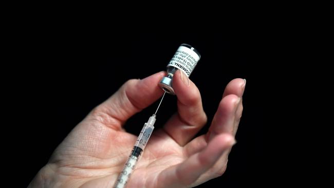 A nurse prepares a syringe of a Covid-19 vaccine. In future Covid and influenza vaccinations could be delivered in one dose. Picture: AFP