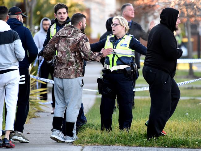 A police officer speaks with a man. Picture: Nicole Garmston