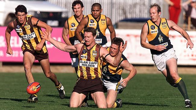 Wangaratta Rovers star Robbie Walker leads North Albury tagger Clint Eckhardt to the ball in the early 2000s.