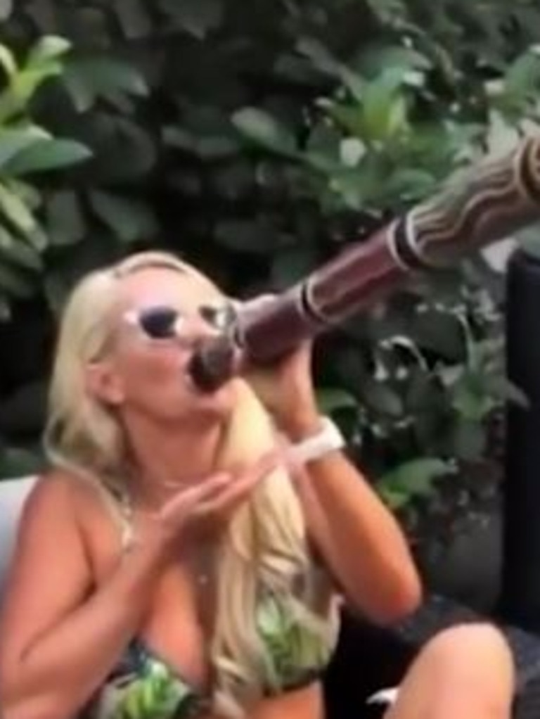 The video shows people cheering the woman on as she drinks beer out of the didgeridoo. Picture: Cassy Walker
