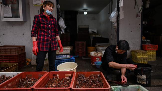 Vendors at a food market in Wuhan. Picture: AFP