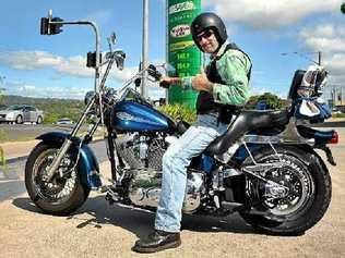 FILL ‘ER UP: Alan Samels of Nambour is pleased to have scored one of the cheapest fuel prices on the Sunshine Coast for his Harley-Davidson motorcycle at the BP on Currie St, Nambour, where fuel prices are much cheaper than on the rest of the Sunshine Coast. Picture: Iain Curry