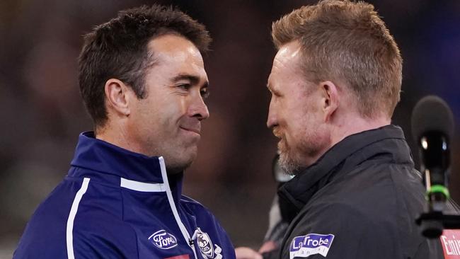 Geelong coach Chris Scott shakes hands with Nathan Buckley before the qualifying final.