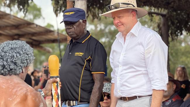 Chairman of the Yothu Yindi Foundation Djawa Yunupingu and Prime Minister Anthony Albanese watch on as Yolngu people perform traditional dance on the Bunggul grounds for the official opening ceremony of Garma Festival. Picture: Fia Walsh.