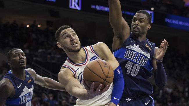 Philadelphia 76ers' Ben Simmons, centre, in action against the Dallas Mavericks