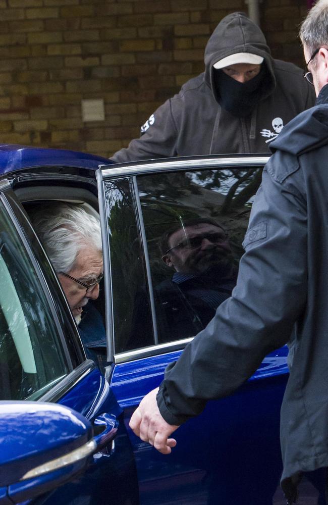 Rolf Harris being protected by men in plain clothes, after being released on bail from HMP Stafford. Picture: Ben Stevens / i-Images