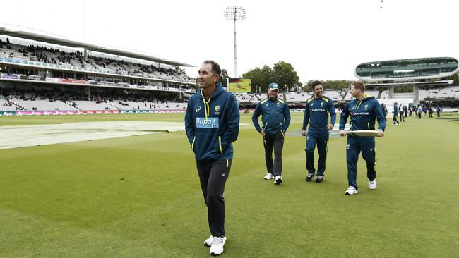 Australian coach Justin Langer, with (from left) Steve Waugh, Travis Head and Steve Smith in tow, inspects a sodden Lord’s yesterday. Picture: Getty Images