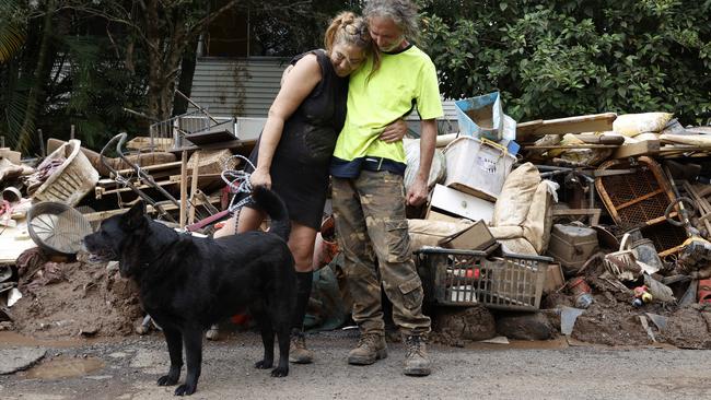 Sarah Behrens with her dog Chuey and friend Stu French who helped clean out her house at 35 Ostrom St, South Lismore. Picture: Jonathan Ng