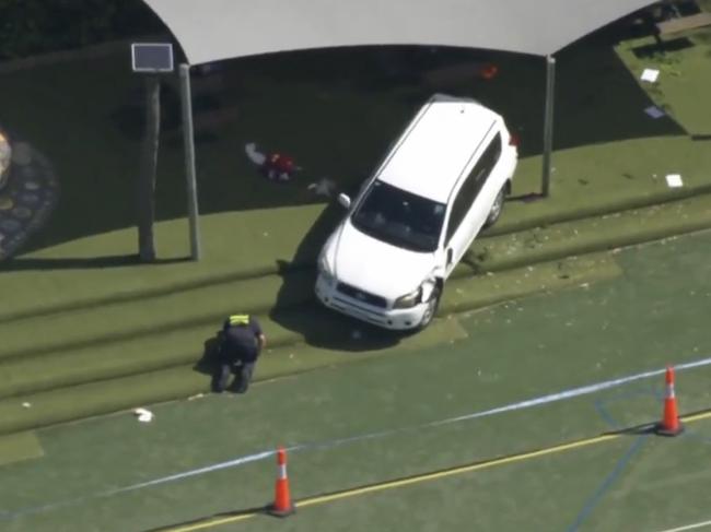 A police officer inspects the scene of the crash. Picture: Seven News