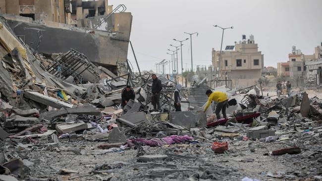 People inspect the damage to their homes in the southern city of Khan Younis after their towers were destroyed by Israeli airstrikes on Sunday. Picture: Getty Images