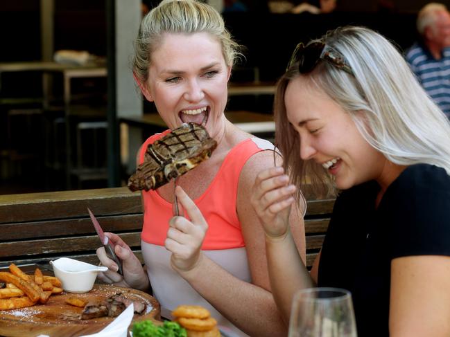 Meat. Jenna Simons and Ashleigh Wheeldon get stuck into a steak at the Plough Inn at Southbank. Pic Mark Calleja