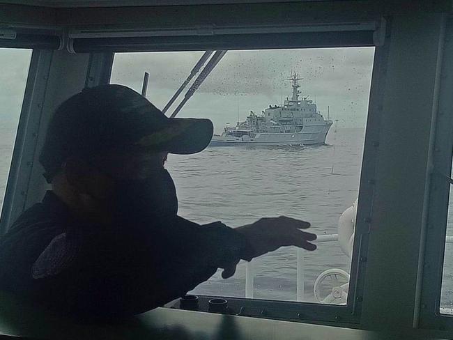 A picture taken from the command deck of the Philippines Coast Guard vessel BRB Cabra, showing the intruding Chinese naval survey vessel in the background. Picture: Philippines Coast Guard.