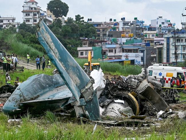 Security personnel inspect the remains of a Saurya Airlines flight after it crashed during takeoff at Tribhuvan International Airport in Kathmandu. Picture: AFP