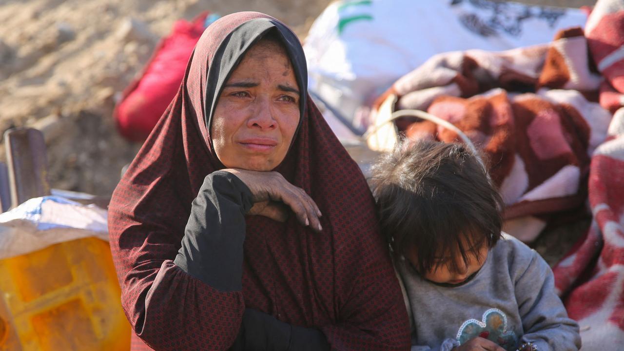 A Palestinian woman and child amid the rubble of Gaza's Al-Shifa hospital. Picture: AFP