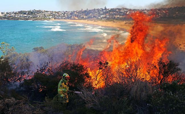 A fire fighter battles the blaze. Picture: David Swift.