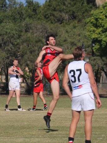 Burleigh Bombers player Josh Hall kicks for goal. Picture credit: Bethany Ryan.