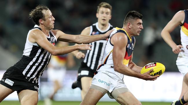 Tough Adelaide midfielder and Magarey runner-up Patrick Wilson tries to escape Port captain Cam Sutcliffe. Picture SARAH REED