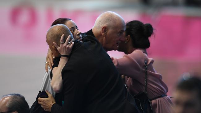 Mourners comfort each other at Friday’s emotional funeral service. Photo: Tricia Watkinson