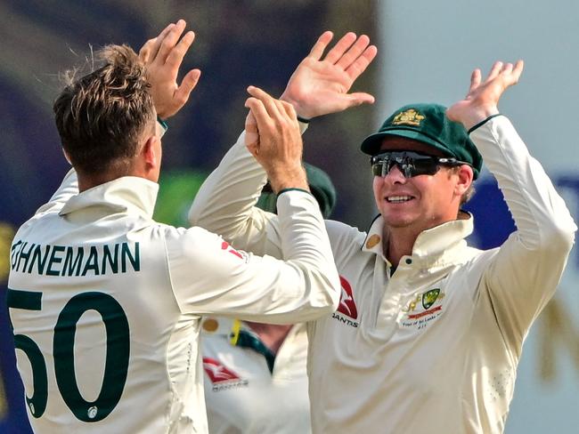 Australia captain Steve Smith celebrates with Matthew Kuhnemann. Picture: AFP