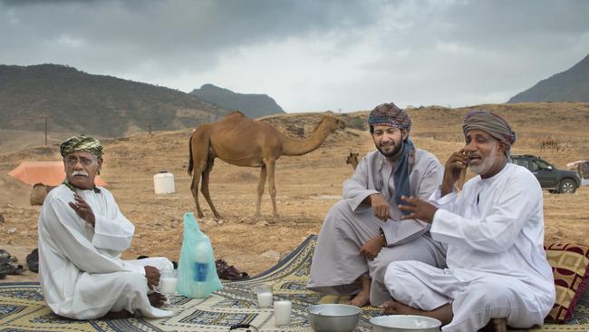 Three men are having a chat in front of theit tent near Salalah in Oman.