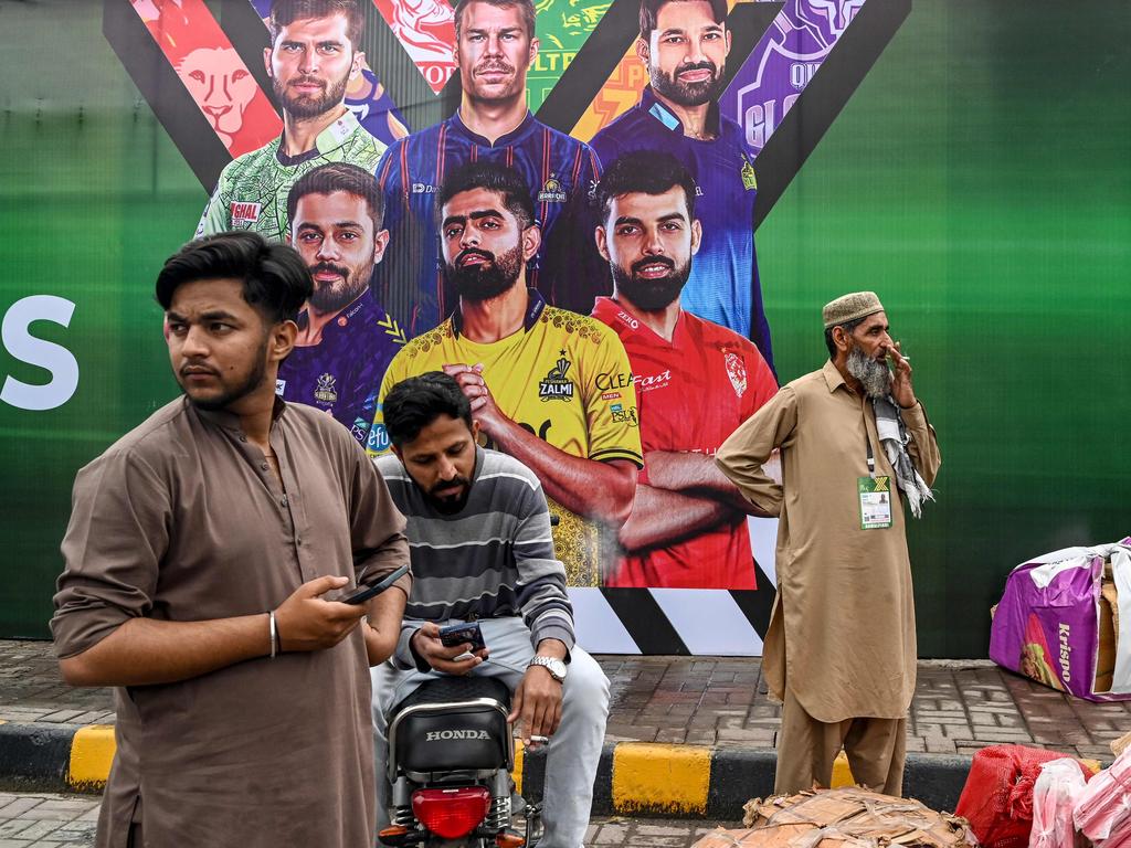 Vendors pack their belongings as they leave Rawalpindi Cricket Stadium following the postponement of the Pakistan Super League. Picture: AFP