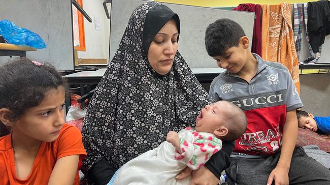 Fadwa Kullab carries her newborn Mohammad at a United Nations Relief and Works Agency for Palestine Refugees in the Near East (UNRWA) in Rafah in the southern Gaza Strip. Picture: Mai YAGHI