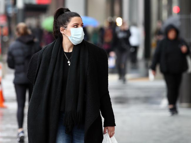 AUCKLAND, NEW ZEALAND - AUGUST 12: People wear masks as they walk in around Britomart on August 12, 2020 in Auckland, New Zealand. Aucklanders have been advised to wear masks to help stop the community spread on Covid-19. COVID-19 restrictions have been reintroduced across New Zealand after four new COVID-19 cases were diagnosed in Auckland. Auckland will be placed in full lockdown for three days from midday on Wednesday, with all residents to work from home unless they are essential workers and all schools and childcare centres to close. The rest of New Zealand will be subject to Level 2 restrictions. The new cases are all in the same family, with health authorities working to trace back the source of the infection. (Photo by Fiona Goodall/Getty Images)