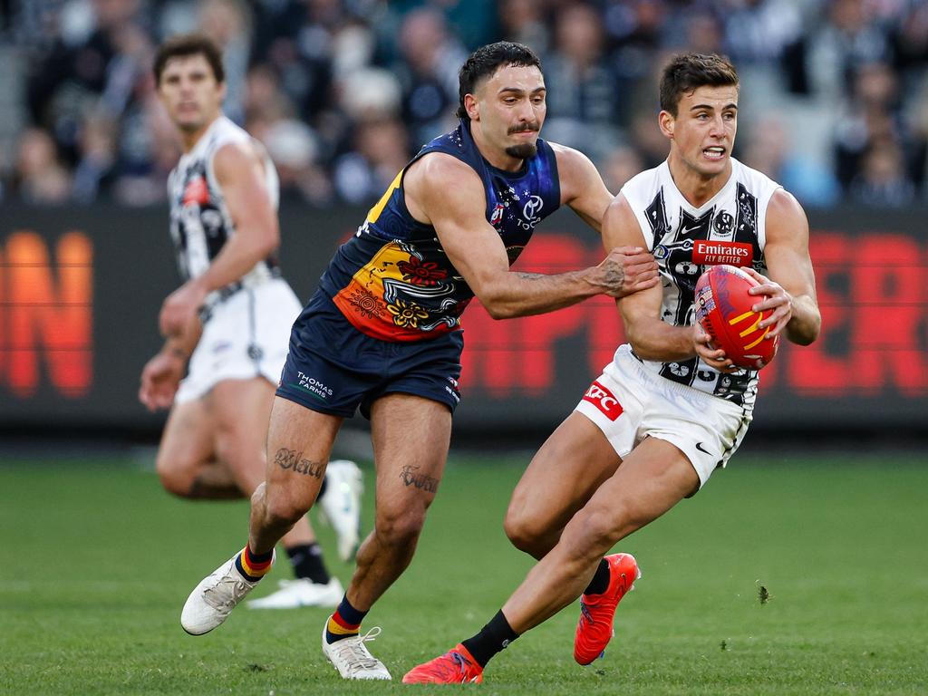 Nick Daicos of the Magpies is tackled by Izak Rankine of the Crows. Picture: Dylan Burns/AFL Photos via Getty Images.