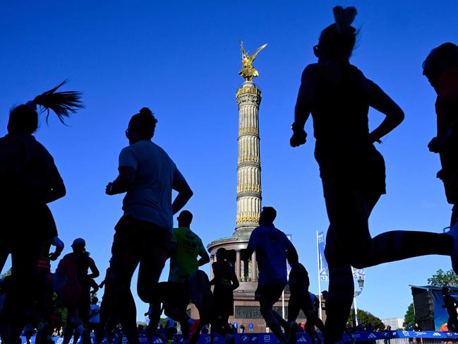 Runners make their way past the landmark Victory Column (Siegessaeule) as they compete in the 50th edition of the Berlin Marathon in Berlin, Germany on September 29, 2024. (Photo by John MACDOUGALL / AFP)