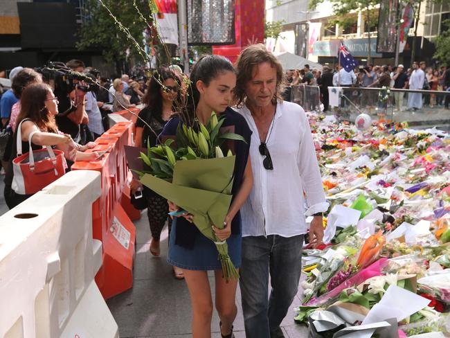 Tori's youngest sister Rada and Father of Tori Johnson, Ken visit the memorial.