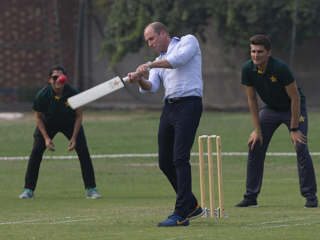 Prince William got stuck into the action as well as Pakistani bowler Shaheen Afridi and captain of Pakistani women cricket team Sana Mir look on. Picture: AP Photo/B.K. Bangash