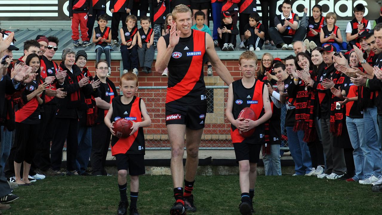 Max Fletcher (left) at age six with brother Mason and father Dustin before his 300th game for the Bombers.