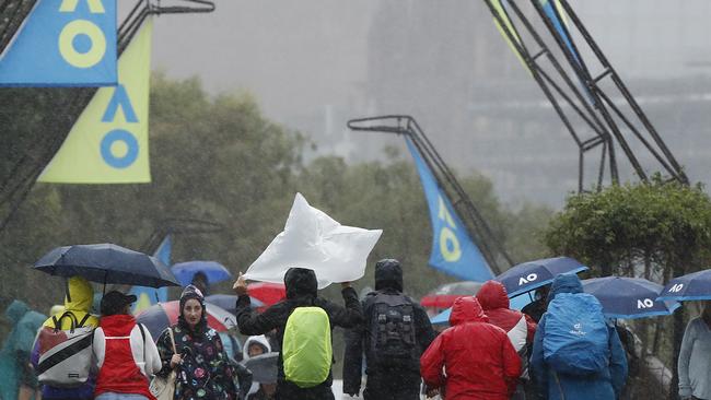 Spectators are drenched making the walk to Melbourne Park. Picture: Daniel Pockett/Getty