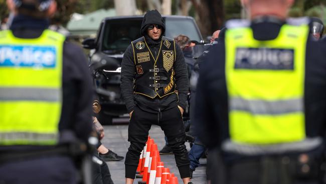 Comanchero Motorcycle Club other members await to have their identifications checked at the United Petrol Station in Tooradin. Picture: Ian Currie