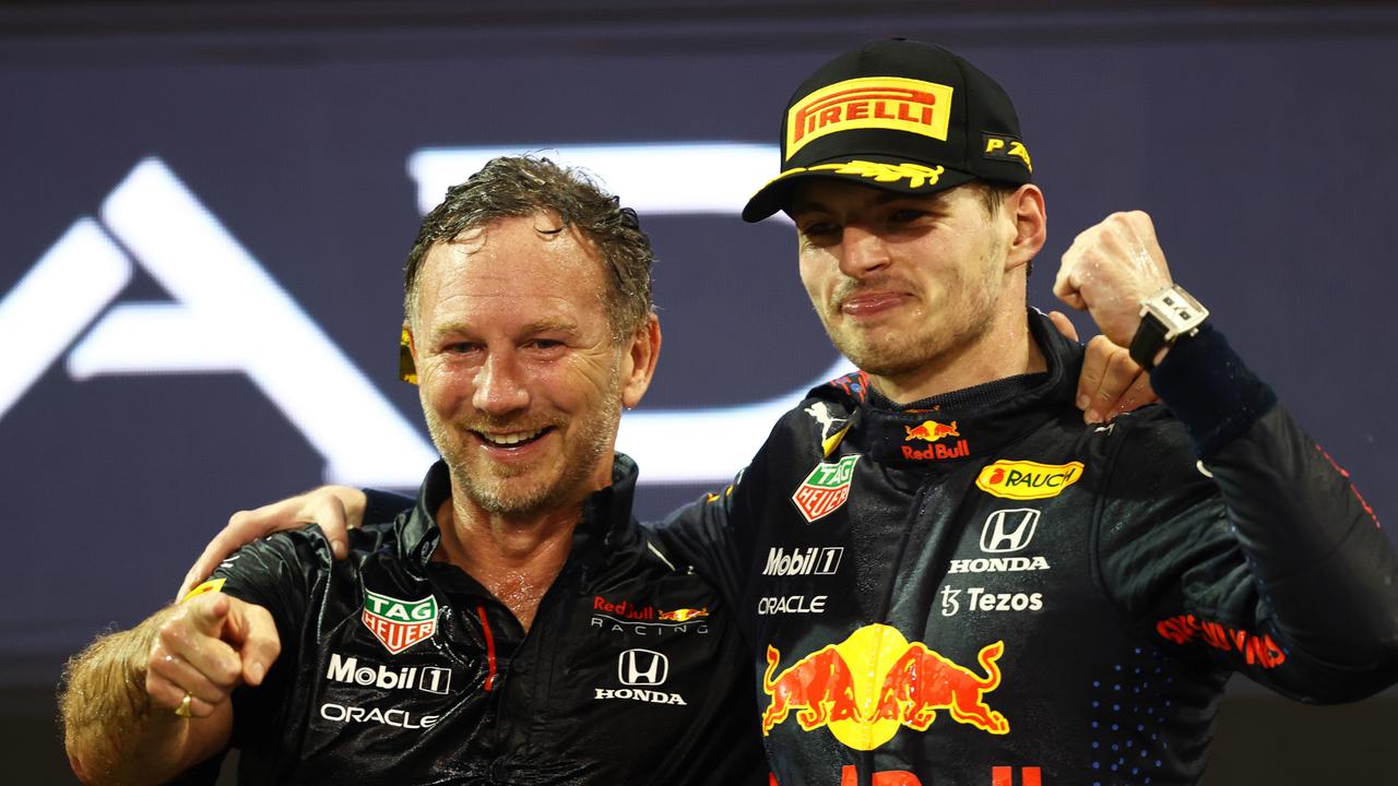 ABU DHABI, UNITED ARAB EMIRATES - DECEMBER 12: Race winner and 2021 F1 World Drivers Champion Max Verstappen of Netherlands and Red Bull Racing celebrates with Red Bull Racing Team Principal Christian Horner on the podium during the F1 Grand Prix of Abu Dhabi at Yas Marina Circuit on December 12, 2021 in Abu Dhabi, United Arab Emirates. (Photo by Bryn Lennon/Getty Images)