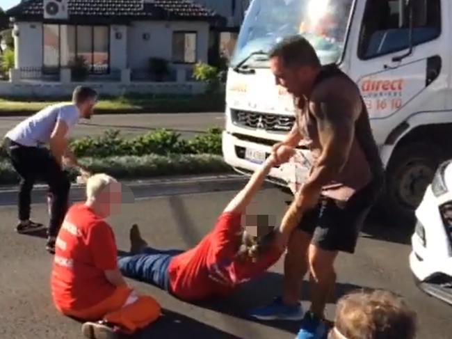 Moment protester dragged across road