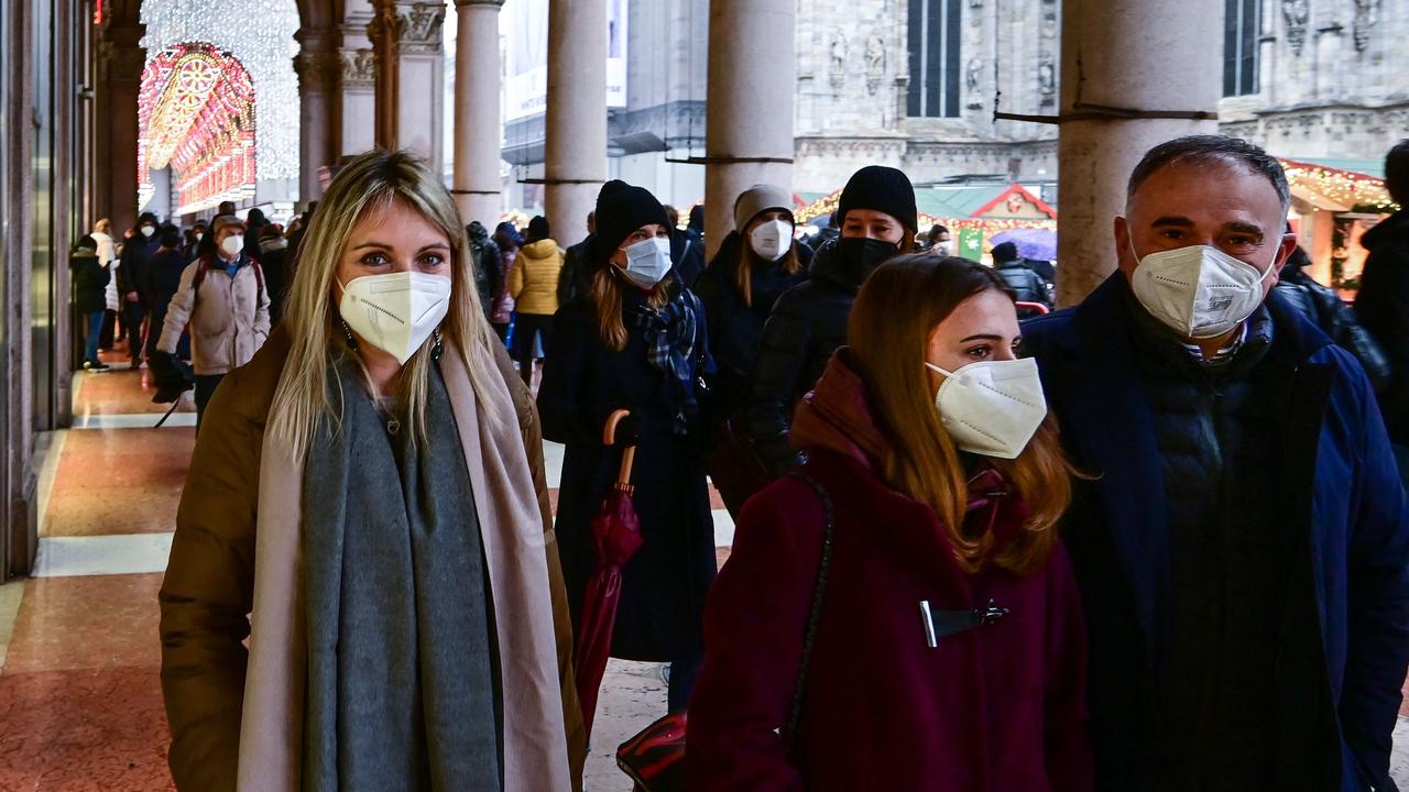 Pedestrians wearing FFP2 protective masks walk near Duomo square in the centre of Milan on January 4, 2022. Picture: Miguel Medina/AFP