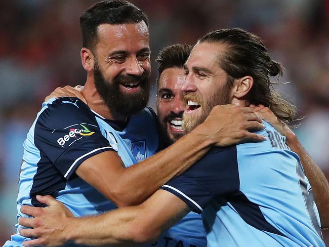 Sydney FCÕs Alex Brosque and Joshua Brilliante (r) congratulate Michael Zullo (centre) on his goal during A-League derby between the Western Sydney Wanderers and Sydney FC at ANZ Stadium. Picture. Phil Hillyard