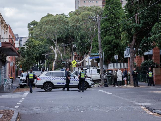 Police cordon off the street and question locals. Picture: Nadir Kinani