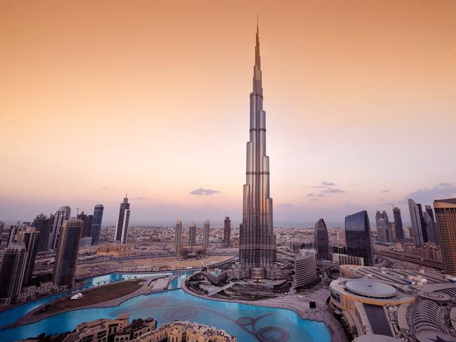 A panoramic view of the Dubai city skyline with the Burj Khalifa shown in the center.  The Burj Khalifa is the tallest building in the world.