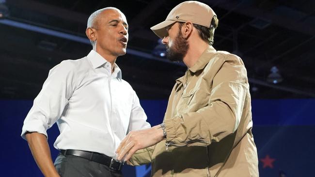 Rapper Eminem, right, greets former president Barack Obama, left, on stage at a campaign rally supporting Democratic presidential nominee Kamala Harris in Detroit. Picture: AP Photo